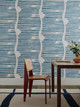 Shore Lines wallpaper in cobalt by Sandra Blow, featuring undulating horizontal stripes and abstract arrow motifs.